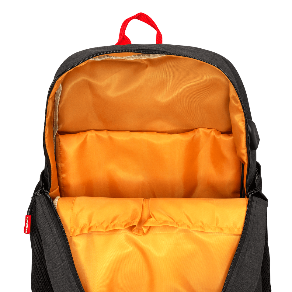  Inside view of poly-fabric backpack in black: red handle on top, orange lining, 2 open pockets, padded 15" laptop sleeve