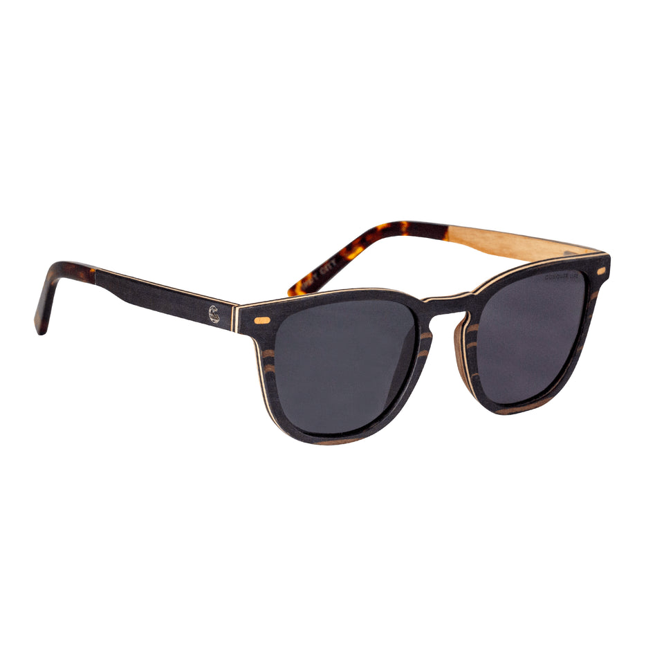 3/4 front view brown wood wayfarer sunglasses: gold corner accents, tortoiseshell acetate arm tips, dark non-mirror lenses