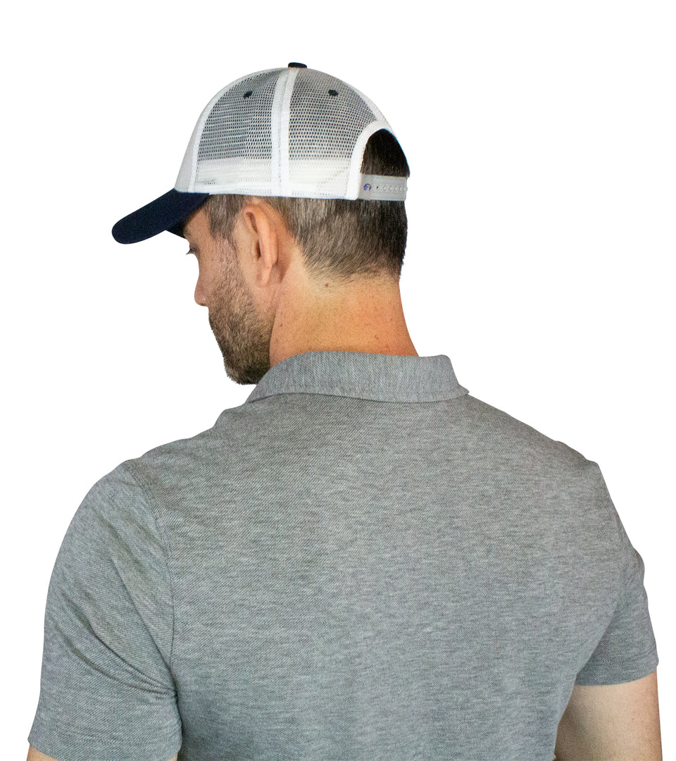 Waist up 3/4 rear view of male model in trucker hat: only blue bill & white mesh back are visible